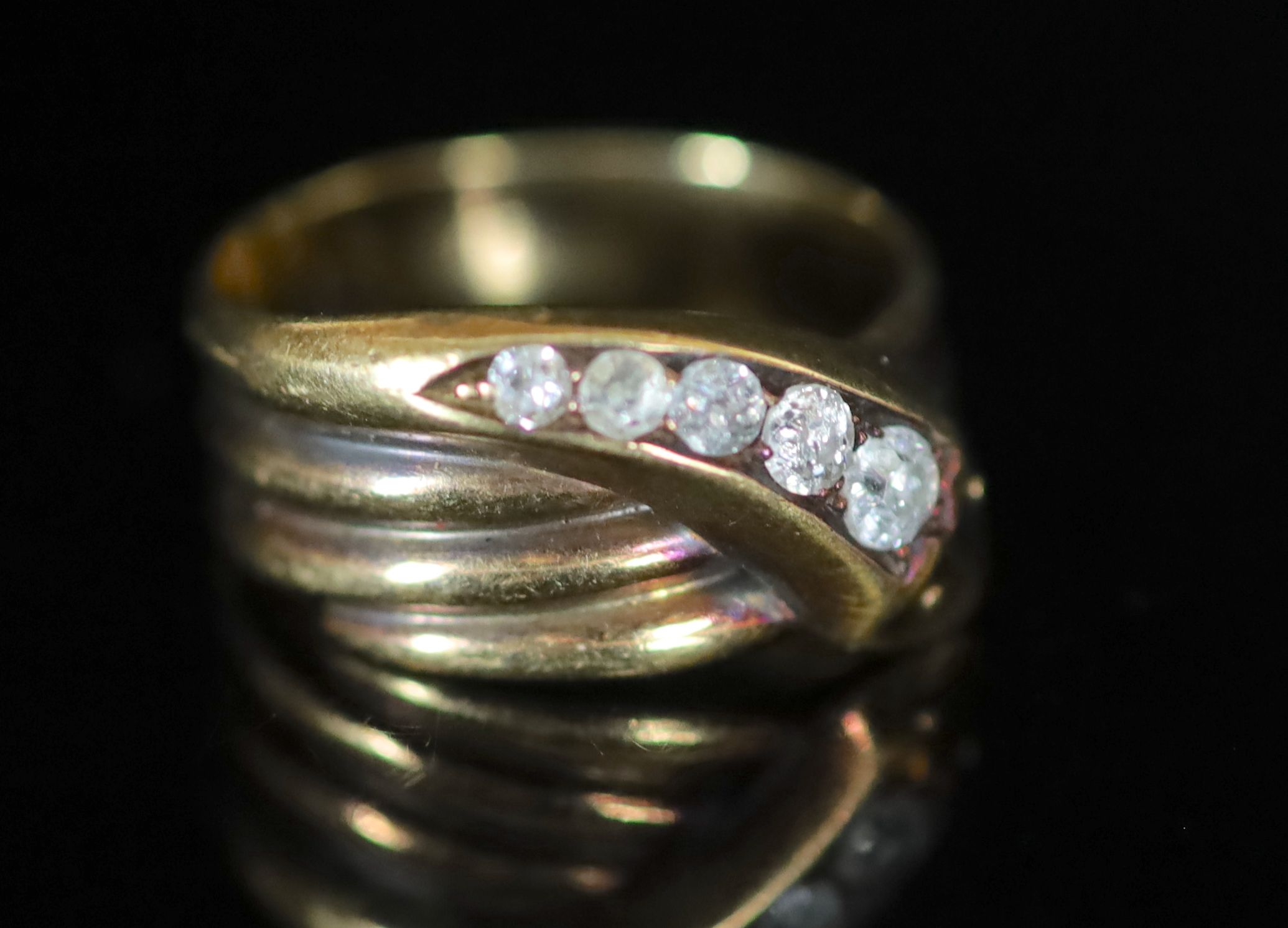 A George V 18ct gold and graduated five stone diamond set coiled serpent ring